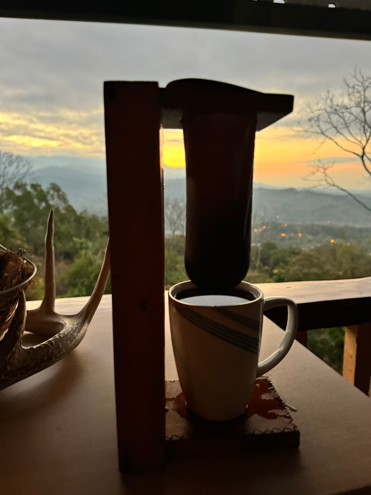 Traditional coffee preparation with sunset view