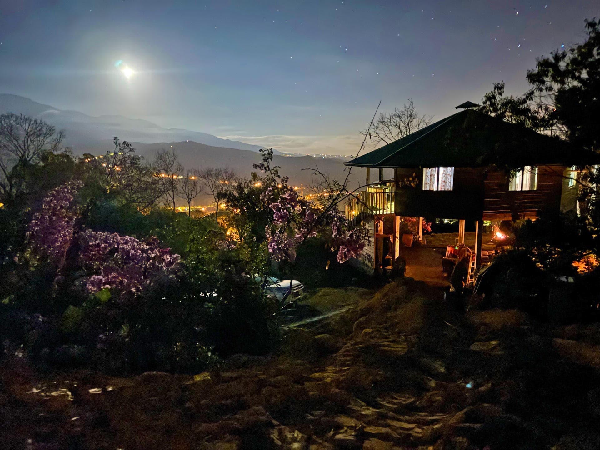 Retreat property at night with moon and city view